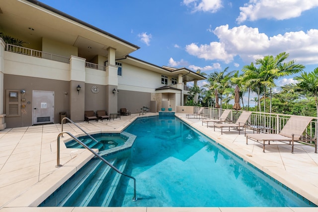 view of pool with a community hot tub and a patio area