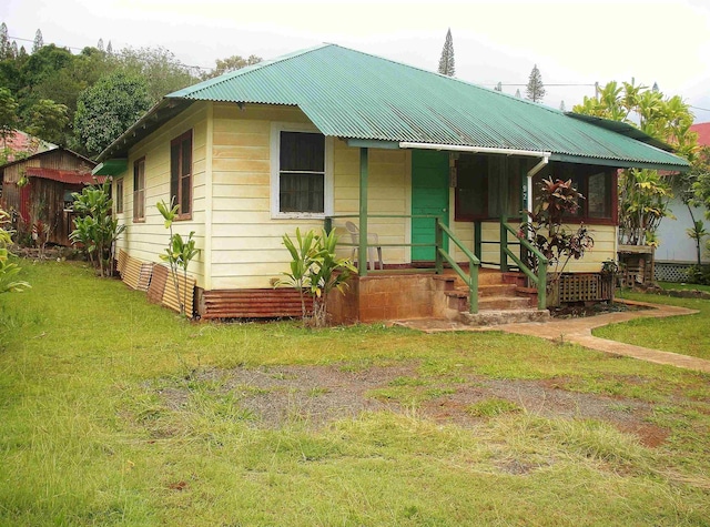928 Lanai Ave, Lanai City, HI 96763 - view of front of property featuring metal roof, a front lawn, and covered porch