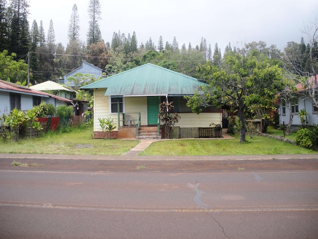 928 Lanai Ave, Lanai City, HI 96763 - view of front of home with a porch, metal roof, and a front yard