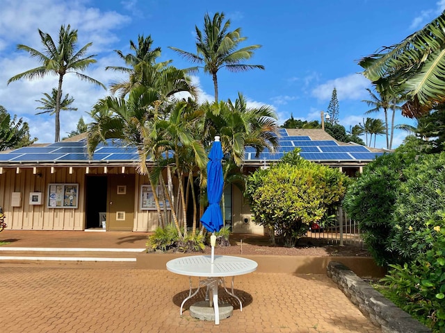 50 Kepuhi Pl Unit 117, Maunaloa, HI 96770 - view of front of property featuring roof mounted solar panels and board and batten siding