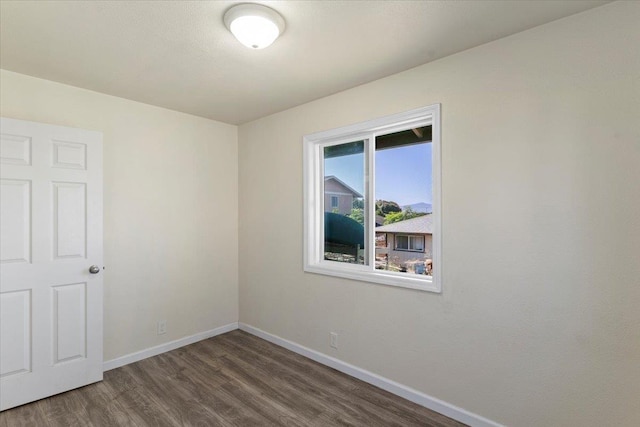 empty room with dark wood-type flooring