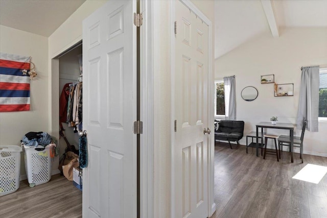 hallway with vaulted ceiling with beams, hardwood / wood-style flooring, and a wealth of natural light