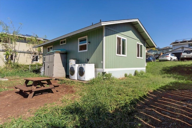 rear view of house featuring washing machine and dryer