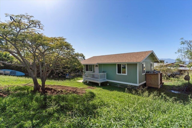 rear view of house with a wooden deck