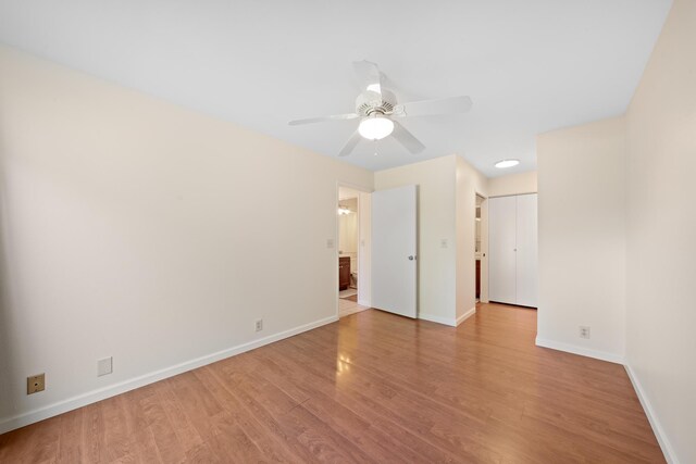 unfurnished room with wood finished floors, baseboards, and a ceiling fan