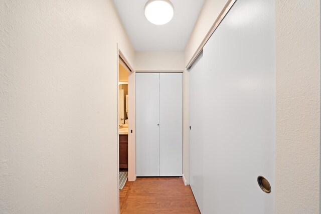 corridor with light wood-style floors
