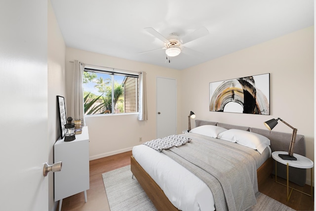 bedroom with wood finished floors, baseboards, and ceiling fan