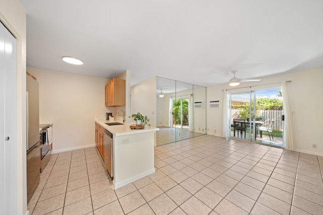 kitchen with a ceiling fan, a sink, light tile patterned floors, light countertops, and a peninsula