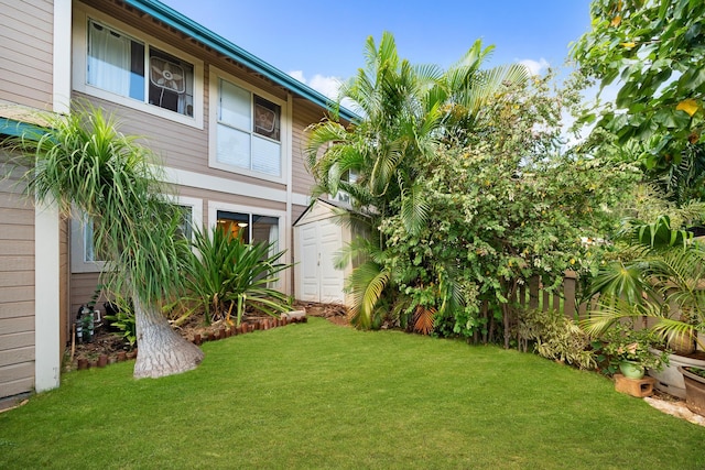 view of green lawn featuring a storage shed and an outdoor structure