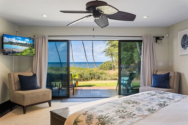 bedroom with access to outside, ceiling fan, and a water view