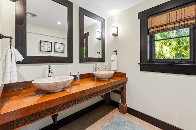 bathroom featuring tile patterned flooring and vanity