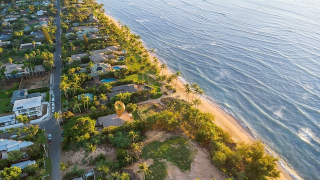 drone / aerial view with a water view and a beach view