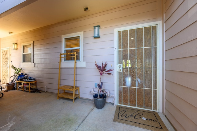 entrance to property with a patio