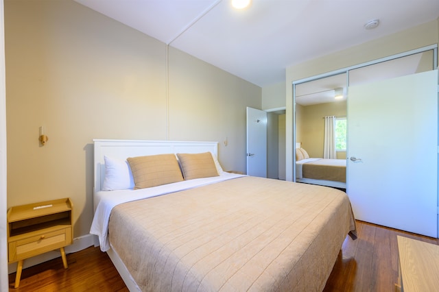 bedroom with a closet and dark hardwood / wood-style flooring