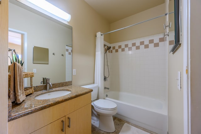 full bathroom with tile patterned floors, tiled shower / bath, toilet, and vanity