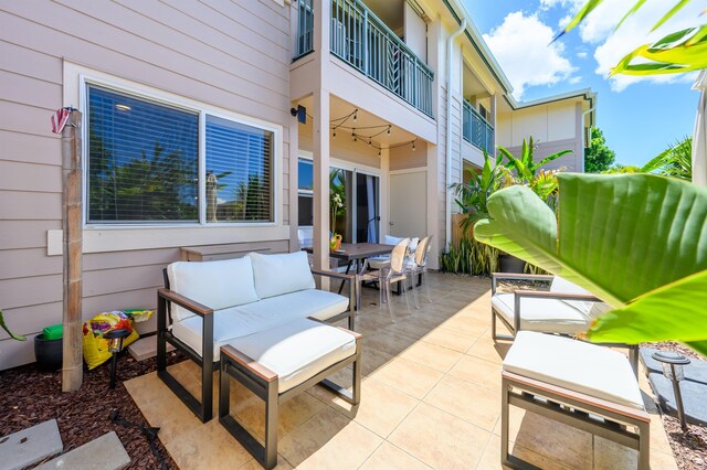 view of patio / terrace with a balcony and an outdoor living space