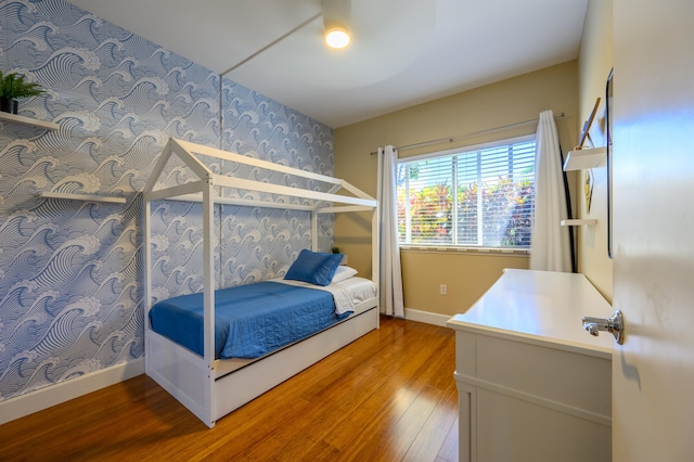 unfurnished bedroom with hardwood / wood-style flooring