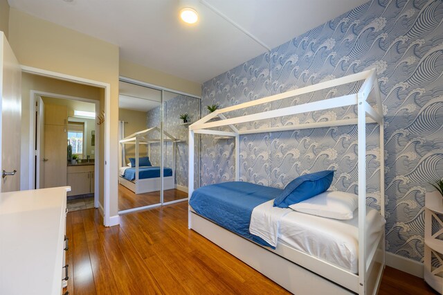 bedroom with hardwood / wood-style flooring and a closet