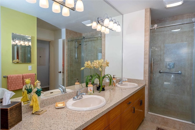 bathroom with a shower with door, vanity, tile patterned flooring, and a notable chandelier