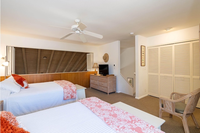 carpeted bedroom with ceiling fan and a closet