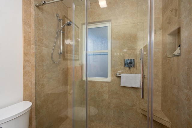 bathroom featuring toilet and walk in shower