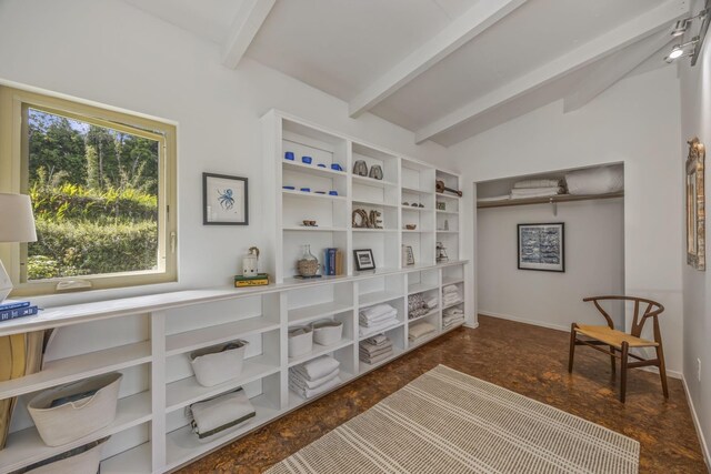 living area with lofted ceiling with beams