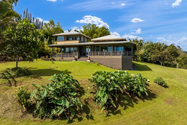 back of property featuring a lawn