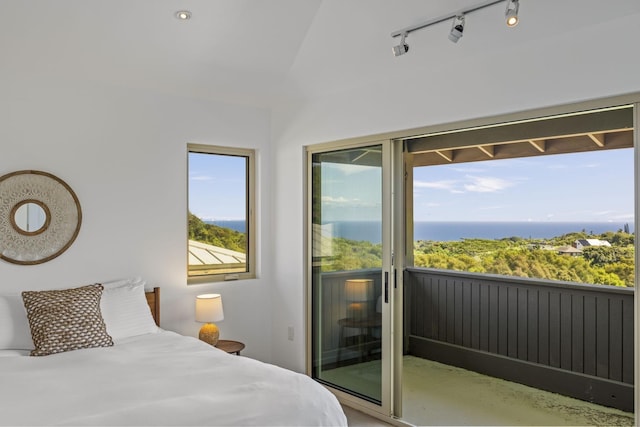 bedroom featuring access to exterior, a water view, and lofted ceiling