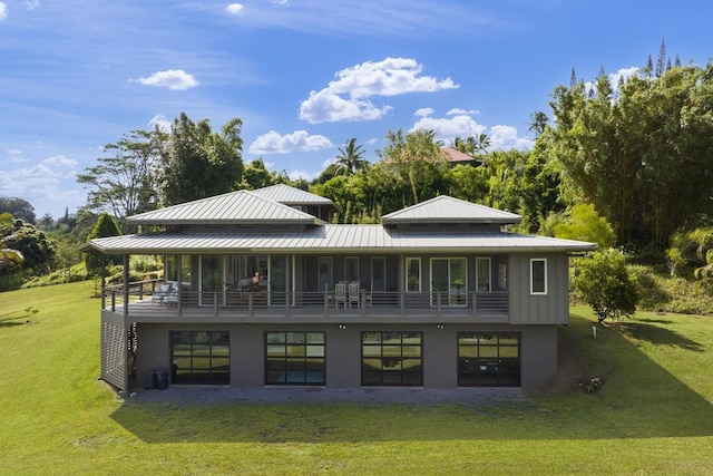 back of house with a yard, metal roof, and a standing seam roof