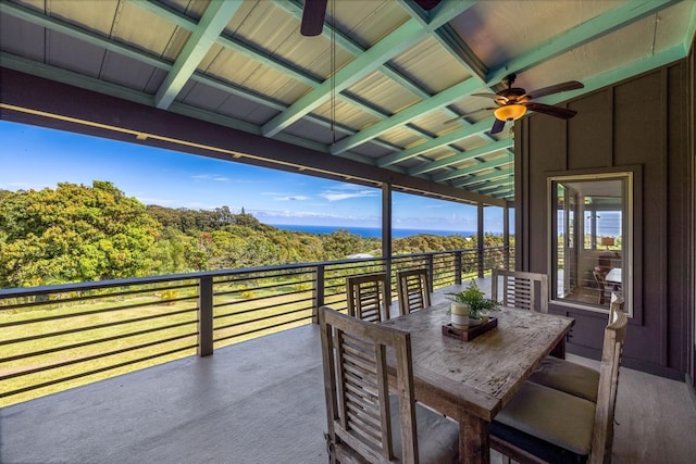 view of patio / terrace featuring a wooded view and a balcony