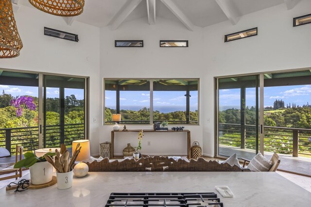 sunroom / solarium with plenty of natural light and lofted ceiling with beams