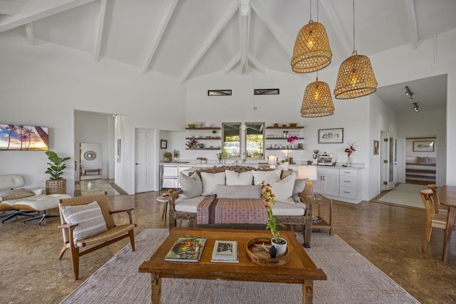 living area with beamed ceiling and high vaulted ceiling