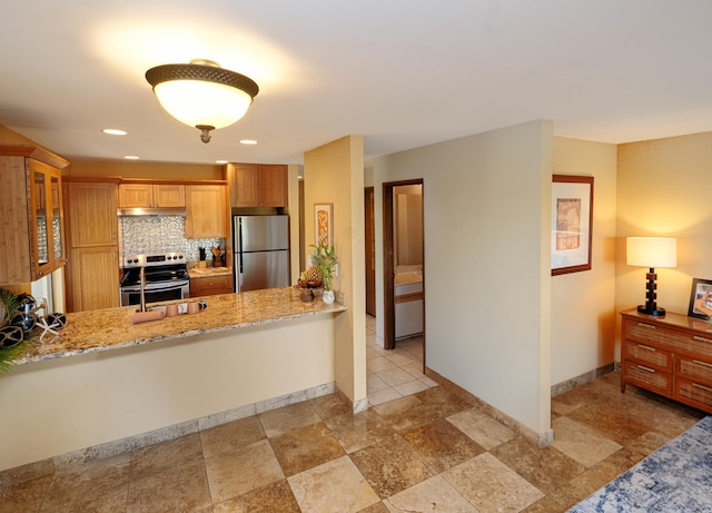 kitchen with light stone counters, backsplash, kitchen peninsula, and appliances with stainless steel finishes