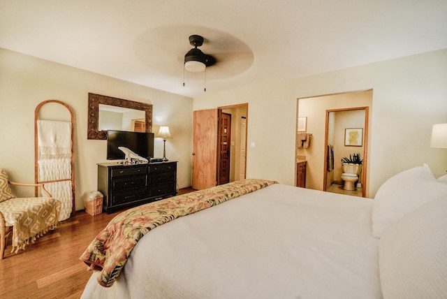 bedroom with ensuite bathroom, hardwood / wood-style floors, and ceiling fan