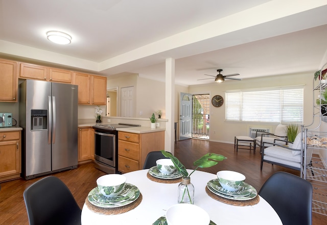 kitchen with dark wood-type flooring, ceiling fan, and appliances with stainless steel finishes