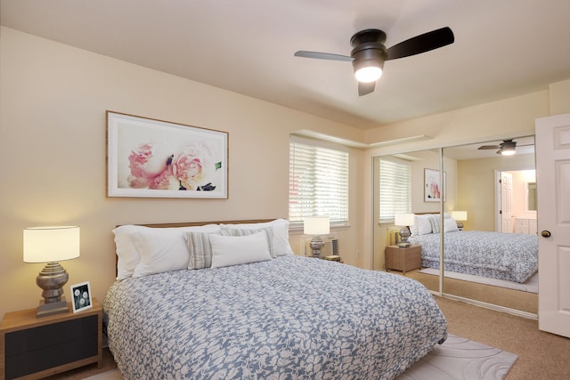 carpeted bedroom with a closet and ceiling fan