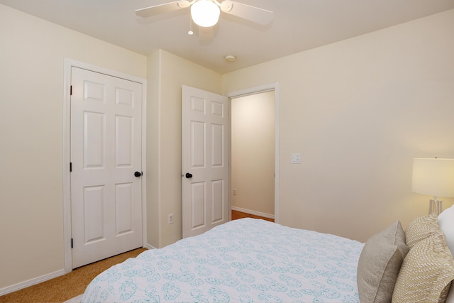 bedroom featuring light carpet, a closet, and ceiling fan