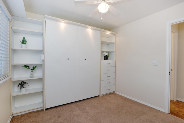 unfurnished bedroom featuring ceiling fan and light carpet