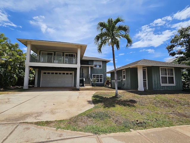 160 Kuli Puu St, Kihei, HI 96753 - view of front of home with driveway, a balcony, an attached garage, and board and batten siding