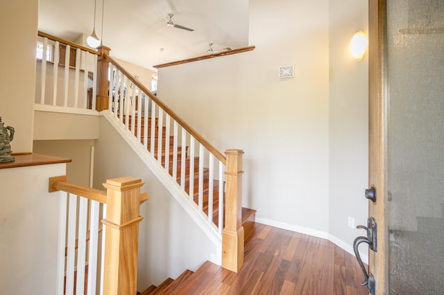 stairway featuring baseboards and wood finished floors