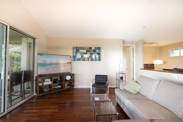 living room featuring dark wood-style flooring, visible vents, and baseboards