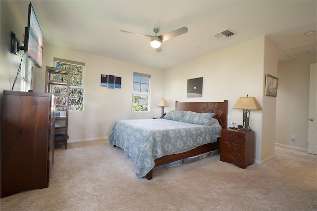 bedroom with multiple windows, visible vents, and light colored carpet