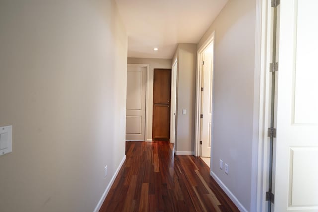 hallway with recessed lighting, dark wood finished floors, and baseboards