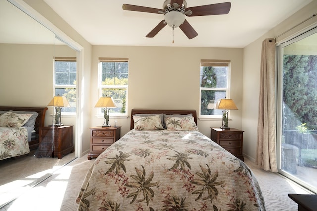 bedroom featuring ceiling fan, baseboards, light colored carpet, and access to exterior