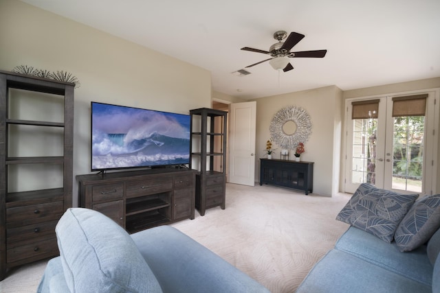 living area featuring light carpet, ceiling fan, french doors, and visible vents