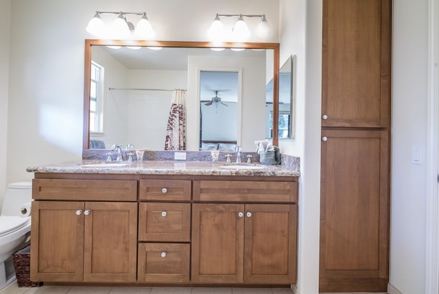 full bath featuring a shower with curtain, a sink, toilet, and double vanity