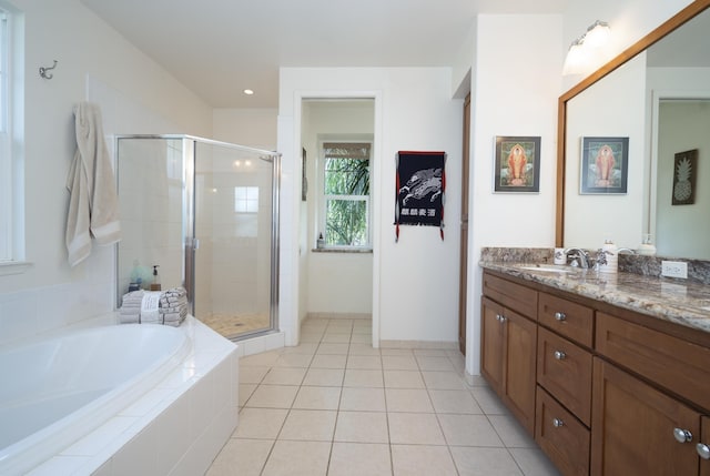 full bath featuring a garden tub, a shower stall, vanity, and tile patterned floors