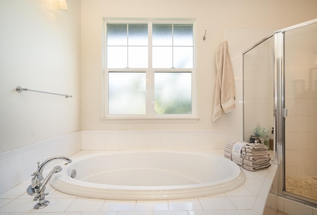 full bathroom with a stall shower and a bath