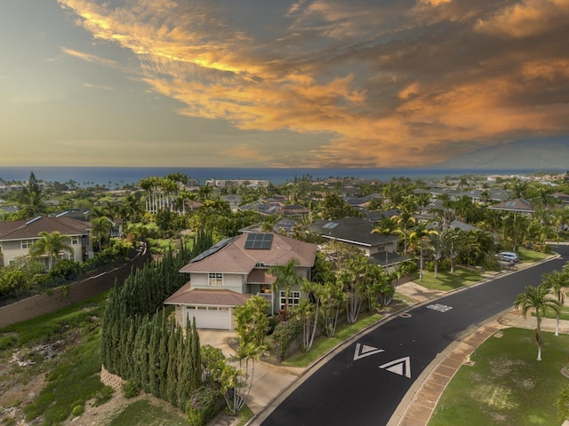 aerial view at dusk featuring a residential view