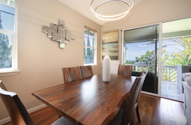 dining area with dark wood finished floors, plenty of natural light, and baseboards